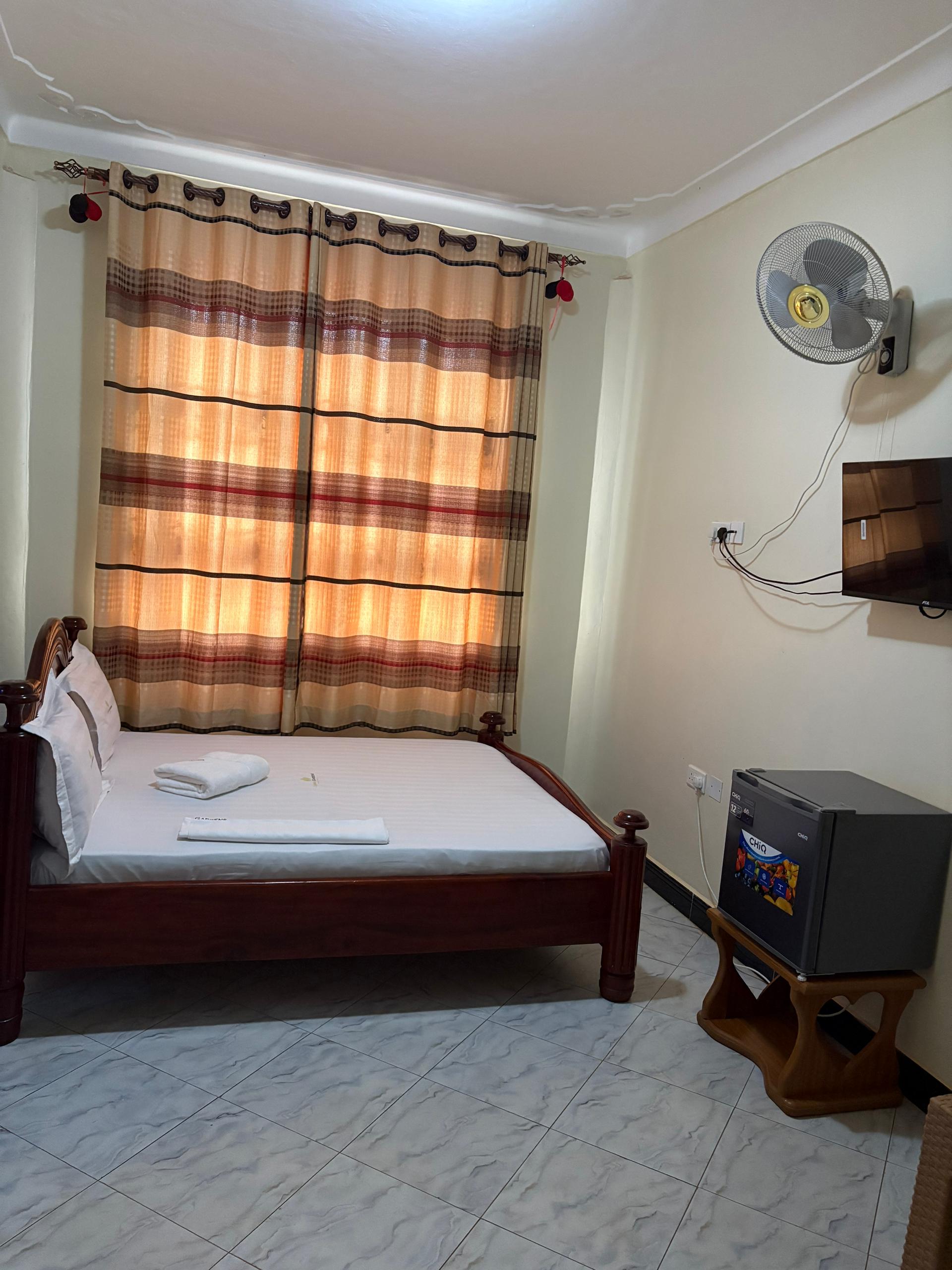 Well-made bed at Danma Gardens